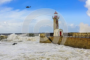 Lighthouse battered by huge waves on Atlantic Ocean