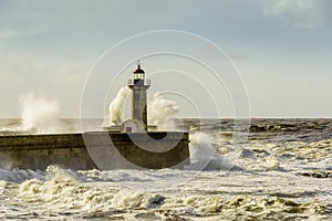 Lighthouse battered by huge waves on Atlantic Ocean