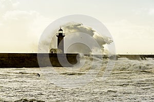 Lighthouse battered by huge waves on Atlantic Ocean