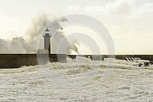 Lighthouse battered by huge waves on Atlantic Ocean