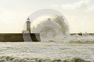 Lighthouse battered by huge waves on Atlantic Ocean