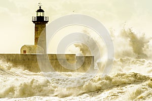 Lighthouse battered by huge waves on Atlantic Ocean