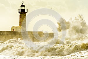 Lighthouse battered by huge waves on Atlantic Ocean