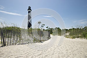 Lighthouse beach scene on ocean shore beautiful landscape scene