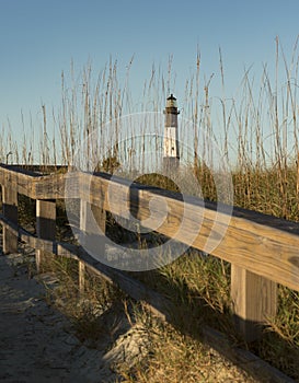 Lighthouse beach scene on ocean shore beautiful landscape scene