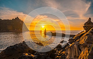 Lighthouse during a beautiful orange sunset in the Pasajes San Juan, Gipuzkoa, Spain