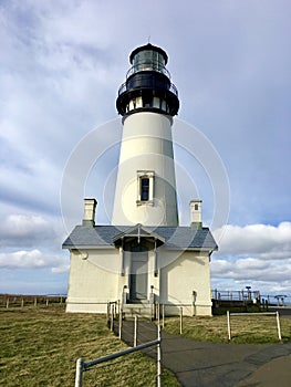 A lighthouse with blue skies and clouds