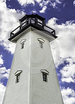 Lighthouse with blue skies and white clouds