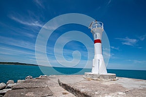 Lighthouse on the blue sky background. Wide angle wiew