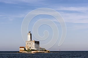 Lighthouse of Bocca island at Lido del Sole beach in Olbia harbor, Sardinia, Italy