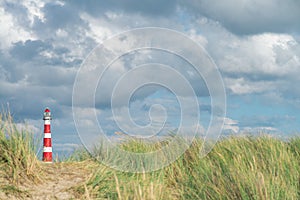 Lighthouse Bornrif Ameland, sea landscape, clear blue cloudy sky in the dunes, high dune grass