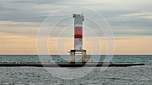 Lighthouse on breakwater with seagulls