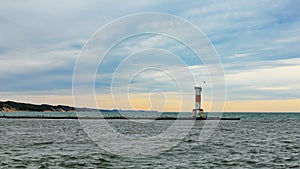 Lighthouse on breakwater with seagulls