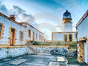 Lighthouse building with tower against to evening sky. Popular Neist Point,