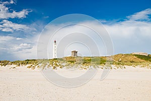 Lighthouse and bunker in the sand dunes on the beach of Blavand, Jutland Denmark Europe