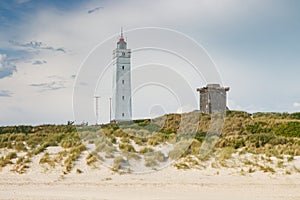 Lighthouse and bunker in the sand dunes on the beach of Blavand, Jutland Denmark Europe