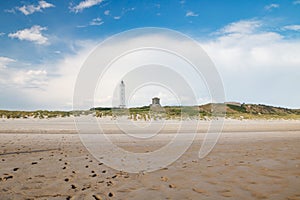 Lighthouse and bunker in the sand dunes on the beach of Blavand, Jutland Denmark Europe