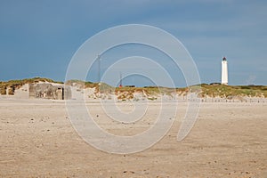 Lighthouse and bunker in the sand dunes on the beach of Blavand, Jutland Denmark Europe