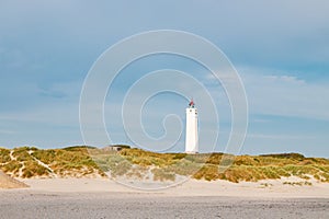 Lighthouse and bunker in the sand dunes on the beach of Blavand, Jutland Denmark Europe