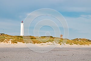 Lighthouse and bunker in the sand dunes on the beach of Blavand, Jutland Denmark Europe