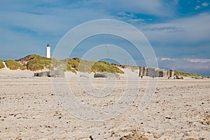 Lighthouse and bunkers in the sand dunes on the beach of Blavand, Jutland Denmark Europe