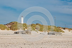 Lighthouse and bunkers in the sand dunes on the beach of Blavand, Jutland Denmark Europe