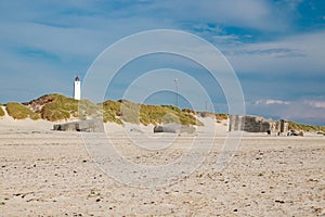 Lighthouse and bunkers in the sand dunes on the beach of Blavand, Jutland Denmark Europe