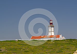 The lighthouse at Cape Espichel, SetÃÂºbal, Portugal photo