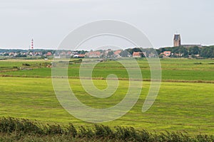 Lighthouse and church of Hollum on the island Ameland photo