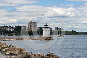 Lighthouse With Cityscape in Background