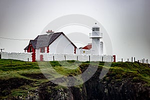 The lighthouse on a cliff in Dingle, Ireland