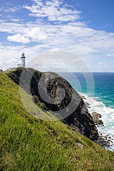 Lighthouse on a cliff by the sea. Vertical picture. Cape Byron. Byron Bay, New South Wales NSW, Australia