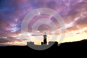 Lighthouse and Cloudy Sky at Sunset