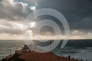 Lighthouse on the coast of Atlantic ocean in Nazare, Portugal.