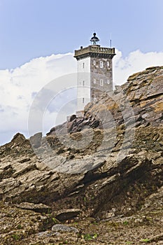 Lighthouse by the coast in Britain with clouds