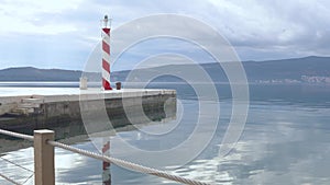 Lighthouse on coast to serve as navigational aid at sea, mark dangerous coastlines, hazardous shoals, reefs, rocks and