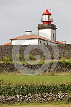 Lighthouse and cornfield in Lajes de Flores, Azores. Portugal photo
