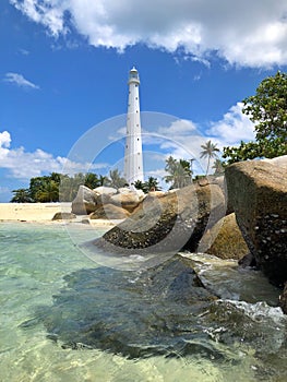Lighthouse at crystal clear water beach