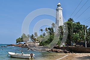 Lighthouse in Dondra and fishing boats.