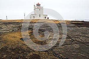 Lighthouse Dyrholaey and Reynisdrangar rocks on the background, Iceland