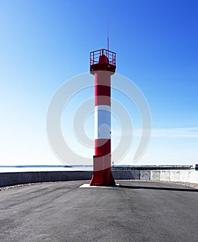 The lighthouse at the edge of the harbor