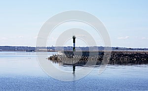 The lighthouse at the edge of the harbor