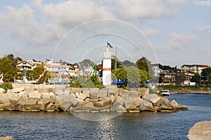 a lighthouse at the entrance of the bay photo