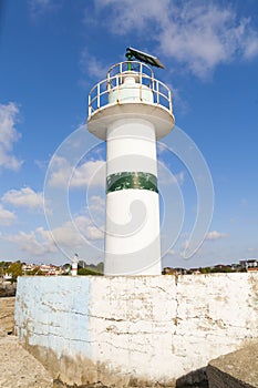 a lighthouse at the entrance of the bay photo