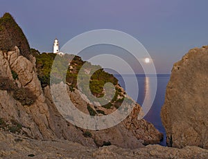Lighthouse Far de capdepera, dusk, moonbeam on sea,rocks and trees, cala ratjada, mallorca, spain