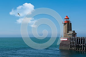 Lighthouse and fishermen at Fecamp in Normandy in France photo