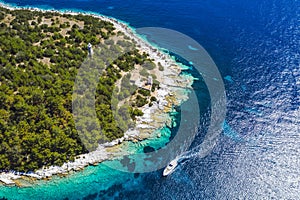 Lighthouse of Fiskardo village. Yacht boat in blue sea arrive in the port in Kefalonia island, Greece