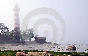 lighthouse in fog on coast