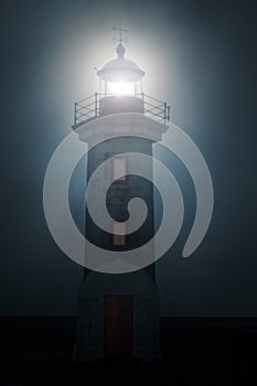 Lighthouse in a foggy night