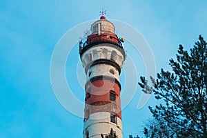 Lighthouse in the forest among the trees. red and white lighthouse